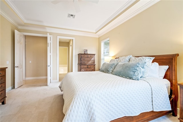 carpeted bedroom featuring ensuite bathroom, ceiling fan, and ornamental molding