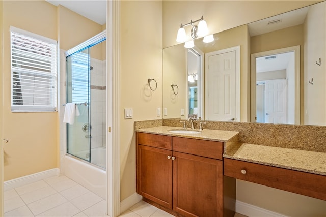 bathroom with shower / bath combination with glass door, tile patterned floors, and vanity