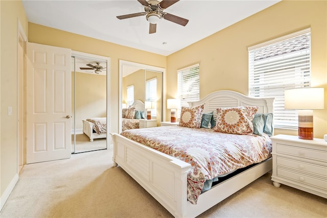 carpeted bedroom with ceiling fan and a closet