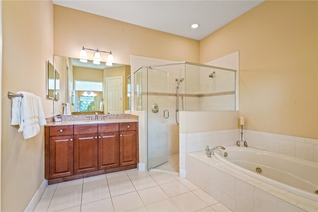 bathroom featuring independent shower and bath, vanity, and tile patterned floors