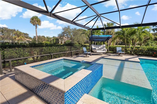 view of pool featuring an in ground hot tub, a lanai, and a patio area