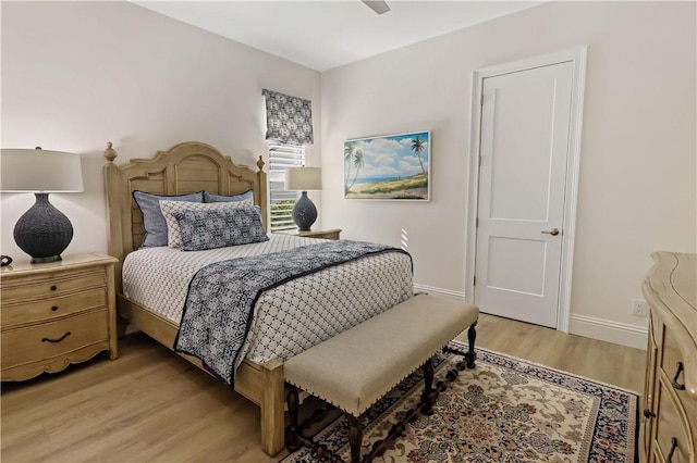 bedroom with light hardwood / wood-style floors and ceiling fan