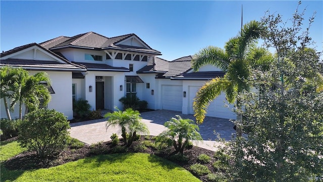 view of front of house featuring a garage and a front yard