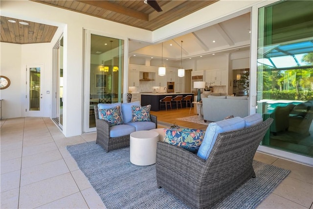 interior space with an outdoor hangout area and ceiling fan