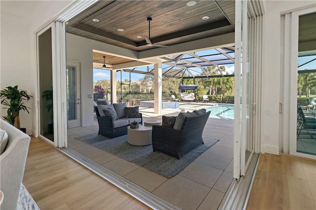 view of patio featuring ceiling fan, a lanai, and an outdoor hangout area