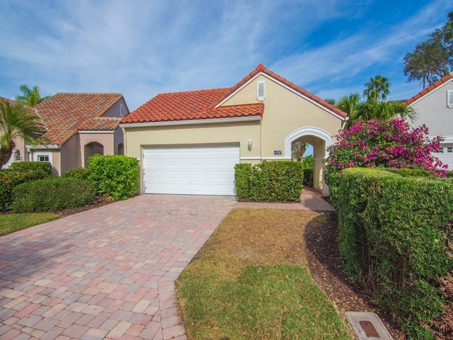 mediterranean / spanish-style house featuring a garage