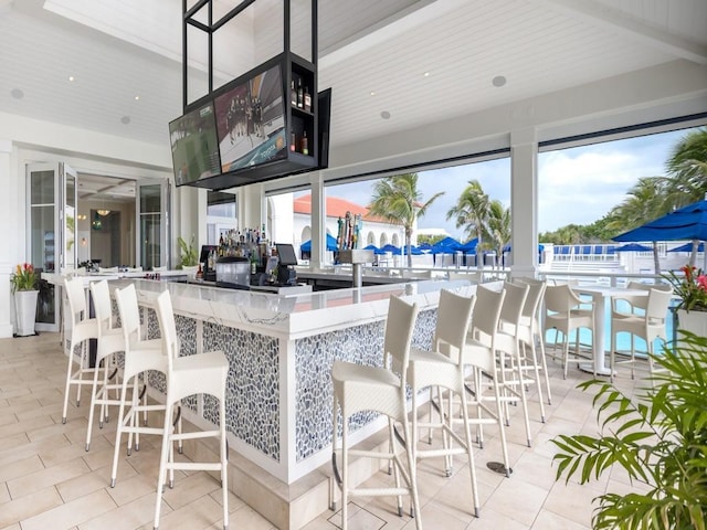 kitchen with light tile patterned flooring and a kitchen breakfast bar