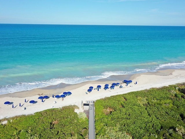 drone / aerial view featuring a view of the beach and a water view