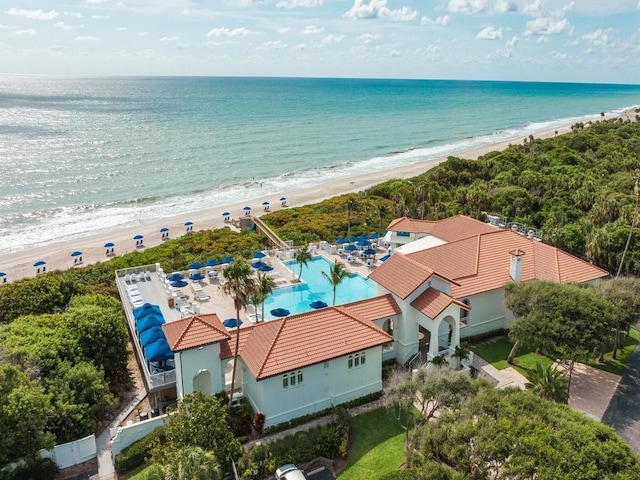 birds eye view of property featuring a water view and a beach view