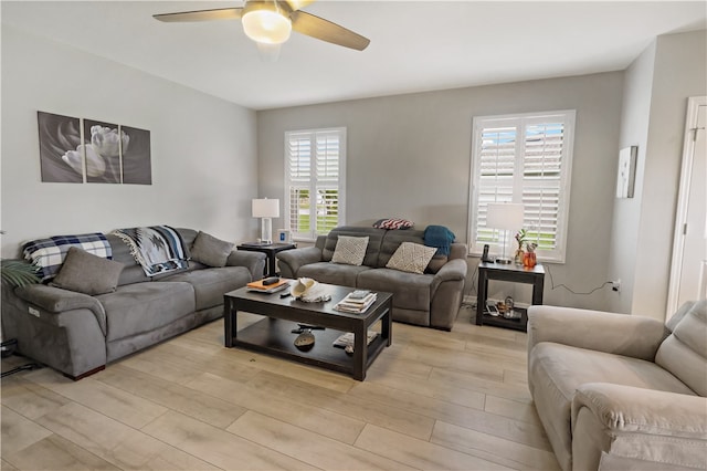 living room with ceiling fan, light hardwood / wood-style floors, and plenty of natural light