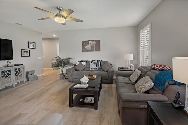 living room featuring ceiling fan and light hardwood / wood-style floors