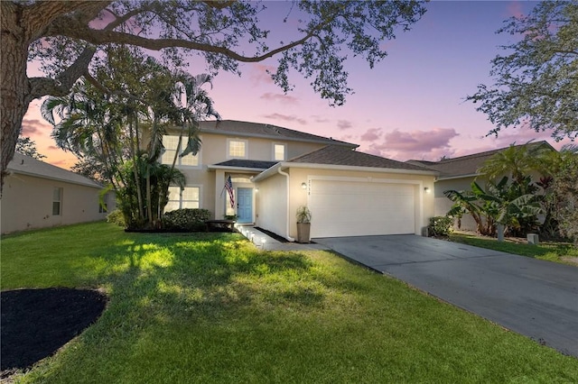 view of front facade with a garage and a lawn