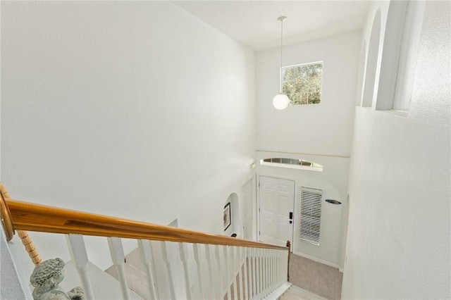 stairs featuring tile patterned flooring