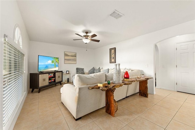 living room featuring light tile patterned floors and ceiling fan