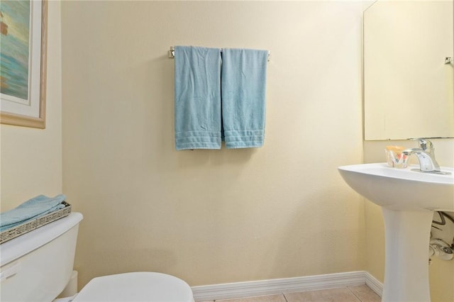 bathroom with tile patterned flooring, sink, and toilet