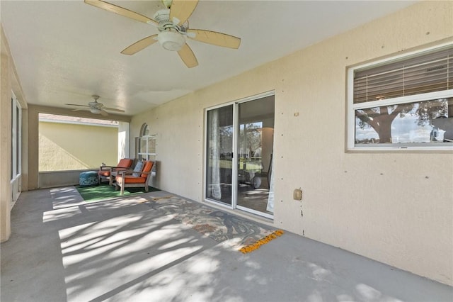 view of patio featuring ceiling fan