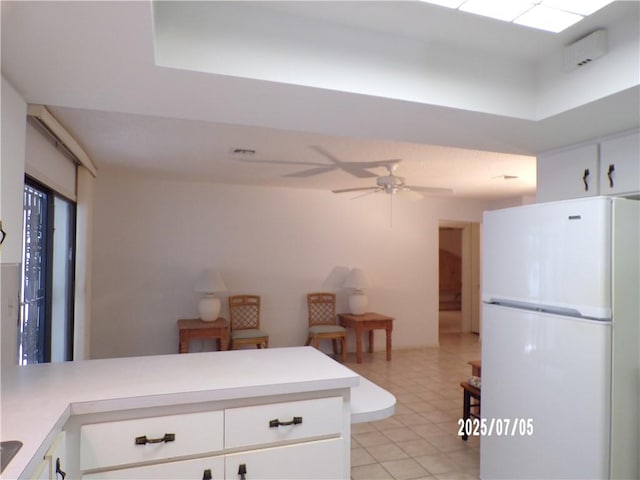 881 48th Ave, Vero Beach, FL 32966 - kitchen featuring freestanding refrigerator, a peninsula, ceiling fan, and light countertops