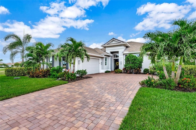 view of front of house with a garage and a front lawn