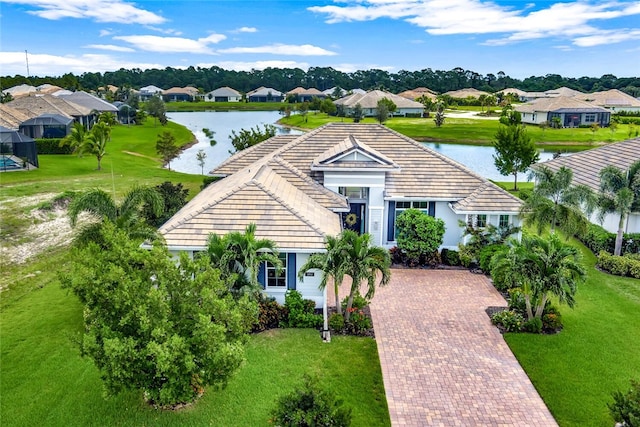 ranch-style home with a front yard and a water view