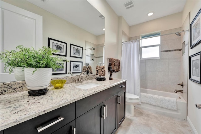 full bathroom with tile patterned flooring, shower / bath combo, vanity, and toilet