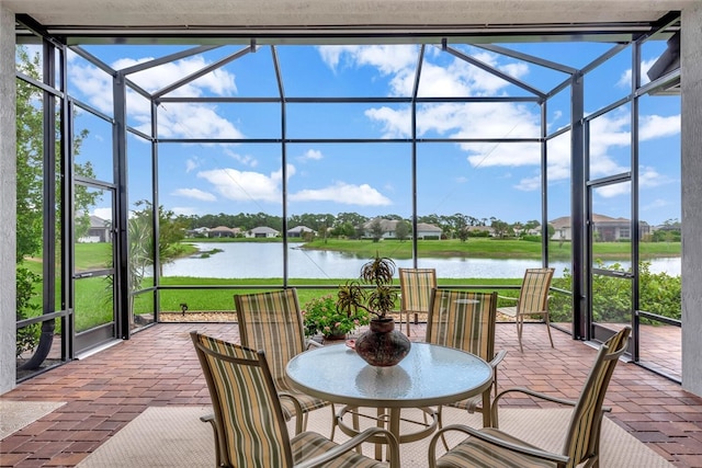 sunroom / solarium with a water view