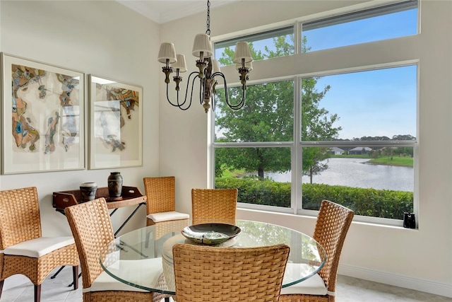 dining space with a water view and an inviting chandelier