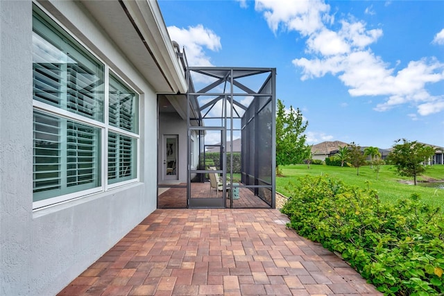 view of patio featuring a lanai