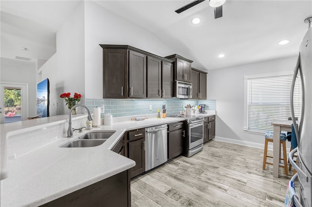 439 Briarcliff Cir, Sebastian, FL 32958 - kitchen featuring stainless steel appliances, a sink, vaulted ceiling, a ceiling fan, and dark brown cabinetry