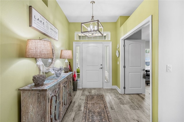 439 Briarcliff Cir, Sebastian, FL 32958 - foyer entrance with a chandelier, light wood-style floors, and baseboards