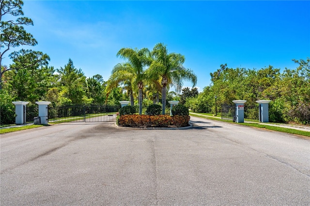 439 Briarcliff Cir, Sebastian, FL 32958 - view of asphalt street with a gate, curbs, a gated entry, and sidewalks