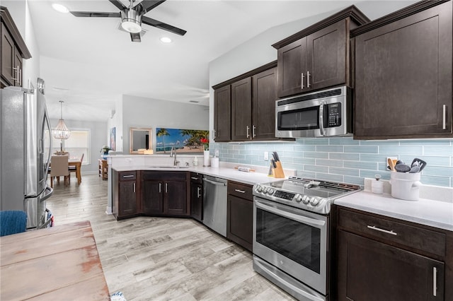 439 Briarcliff Cir, Sebastian, FL 32958 - kitchen featuring appliances with stainless steel finishes, light wood finished floors, ceiling fan, dark brown cabinetry, and tasteful backsplash