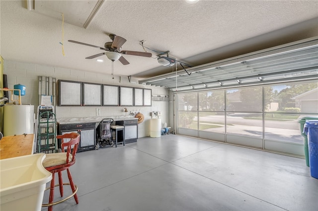 439 Briarcliff Cir, Sebastian, FL 32958 - garage featuring gas water heater, ceiling fan, concrete block wall, and a garage door opener