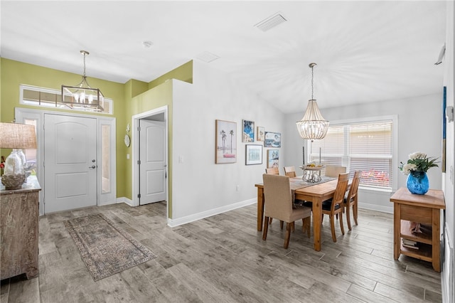 439 Briarcliff Cir, Sebastian, FL 32958 - dining space featuring a chandelier, wood finished floors, baseboards, and lofted ceiling