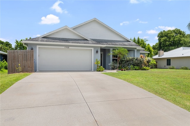 1368 Scroll St, Sebastian, FL 32958 - view of front of property with an attached garage, concrete driveway, stucco siding, and a shingled roof