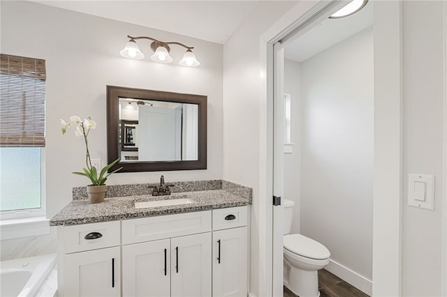 1368 Scroll St, Sebastian, FL 32958 - bathroom featuring vanity, a tub to relax in, and wood finished floors