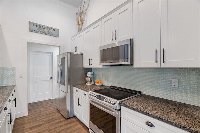 1368 Scroll St, Sebastian, FL 32958 - kitchen featuring appliances with stainless steel finishes, tasteful backsplash, dark stone counters, and dark wood finished floors