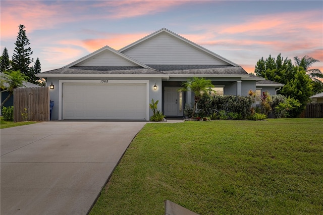 1368 Scroll St, Sebastian, FL 32958 - view of front facade with an attached garage, concrete driveway, roof with shingles, and stucco siding