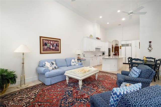 1624 Weybridge Cir, Vero Beach, FL 32963 - living room featuring arched walkways, a high ceiling, ornamental molding, and ceiling fan