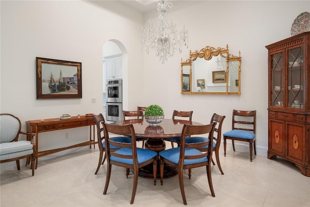 1624 Weybridge Cir, Vero Beach, FL 32963 - dining room with arched walkways, baseboards, and a notable chandelier