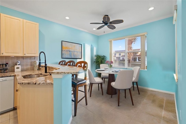 dining room with crown molding, sink, light tile patterned floors, and ceiling fan