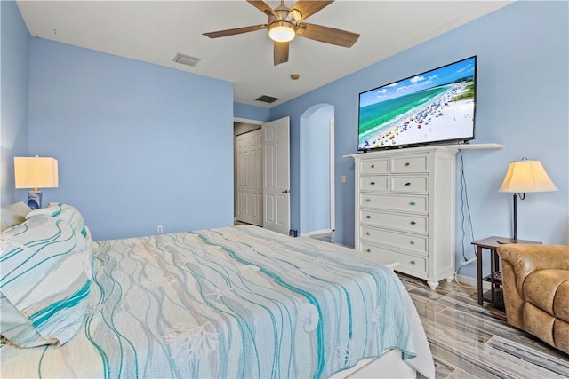 bedroom with ceiling fan and light hardwood / wood-style flooring