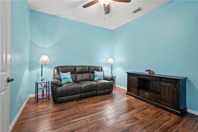 living room featuring ceiling fan and dark hardwood / wood-style flooring