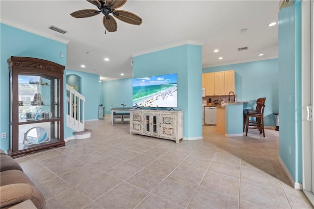 living room featuring ornamental molding, light tile patterned floors, and ceiling fan