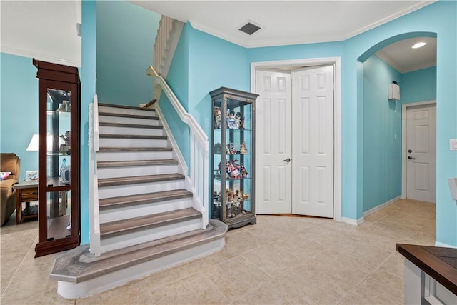 tiled entrance foyer with crown molding