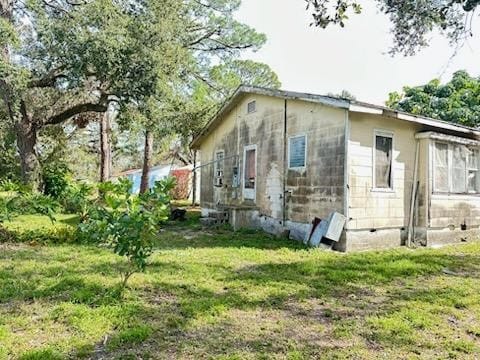 view of property exterior with a lawn