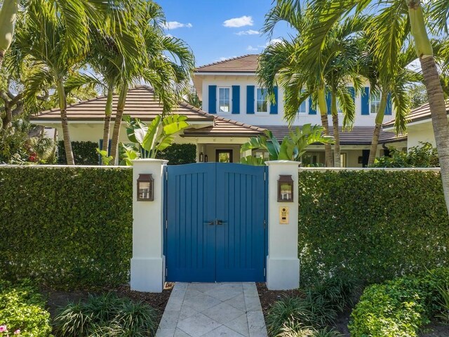 view of gate with a fenced front yard