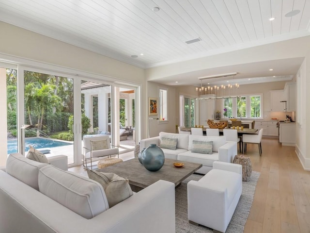 living area featuring recessed lighting, visible vents, light wood-style flooring, and crown molding