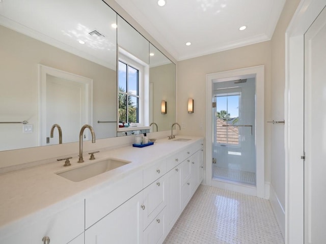 full bathroom featuring visible vents, plenty of natural light, crown molding, and a sink