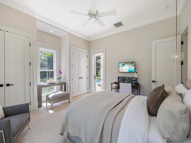 bedroom featuring visible vents, carpet floors, ornamental molding, and a ceiling fan