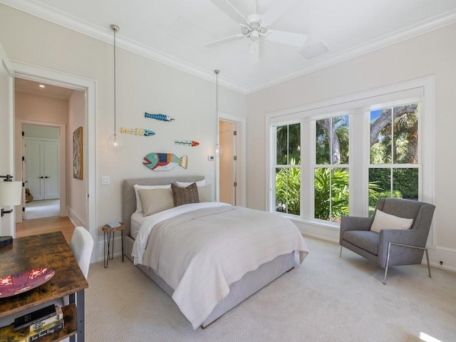 bedroom with ceiling fan, light colored carpet, baseboards, and ornamental molding